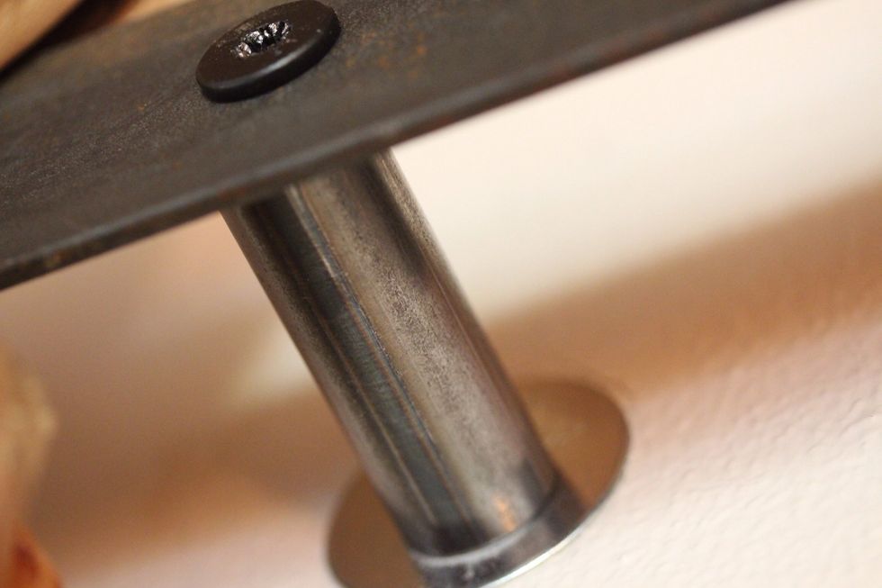 Close up of the bolt and steel connecting the track to the wall. Be sure to allow the screw to be flush to allow the door to pass. Also use washers to distribute weight of connections.