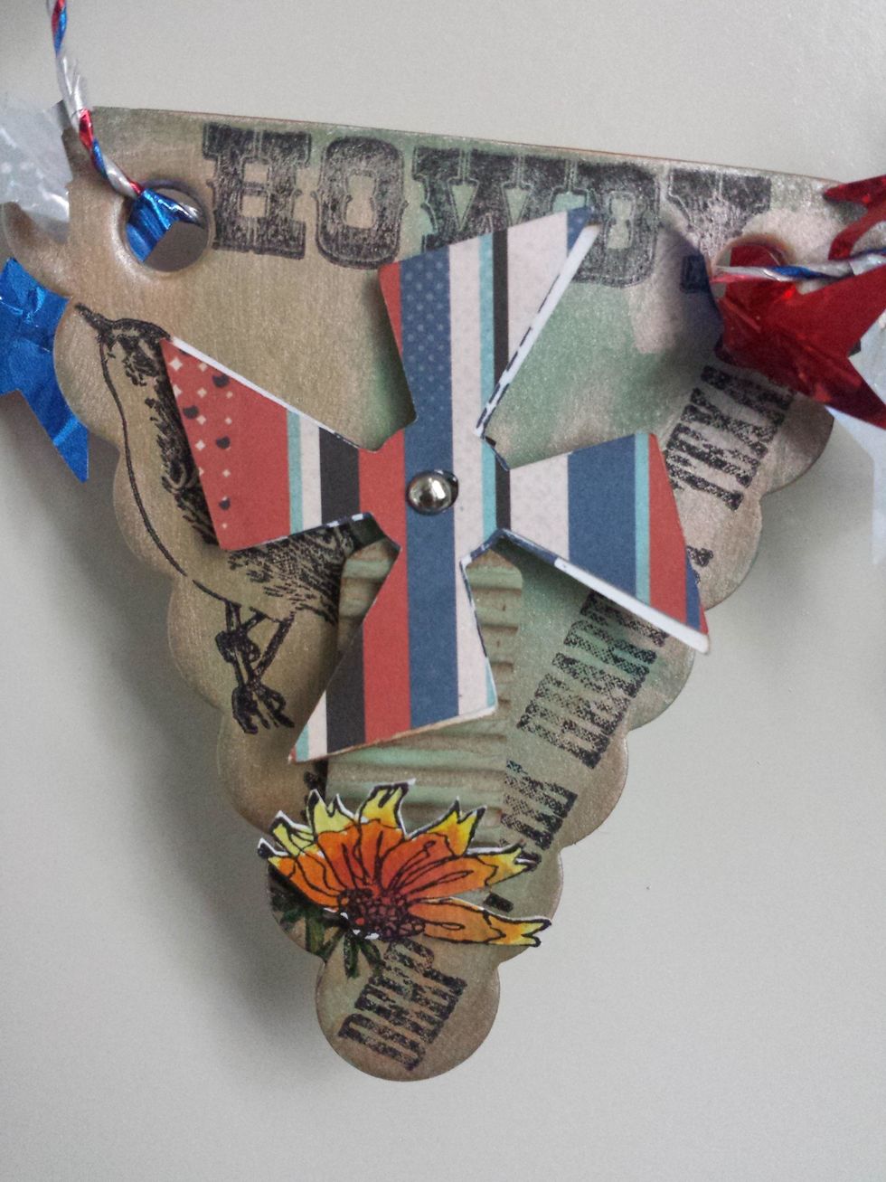 Close up of the "I" I stamped the background of the banner with several Texas stamps, and added a old diecut from a windmill...