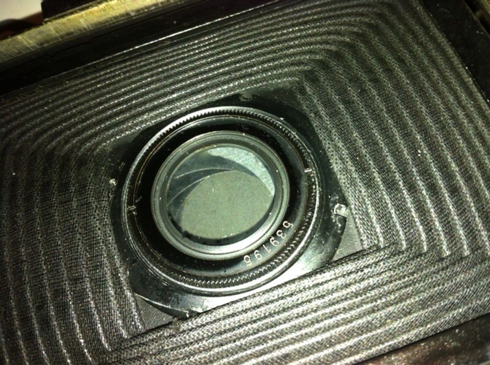 Close your camera and turn it over. Here is the back lens. Hello!! To all the ppl who are joining us. :-)  the notches are for a lens wrench. But we dont have $30 to waste so...