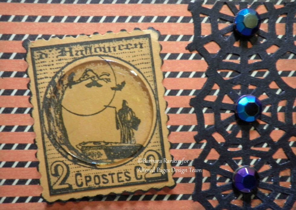 Closeup of SCS Halloween postage stamped onto light orange CS and acrylic bubble added.