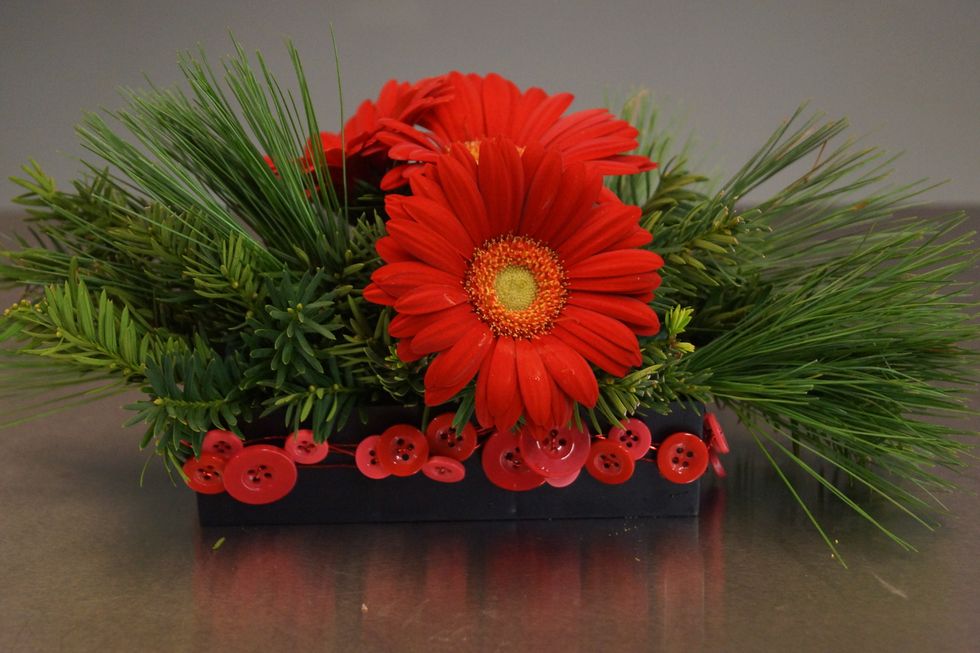 Cluster a third gerbera, creating a triangle of blooms.