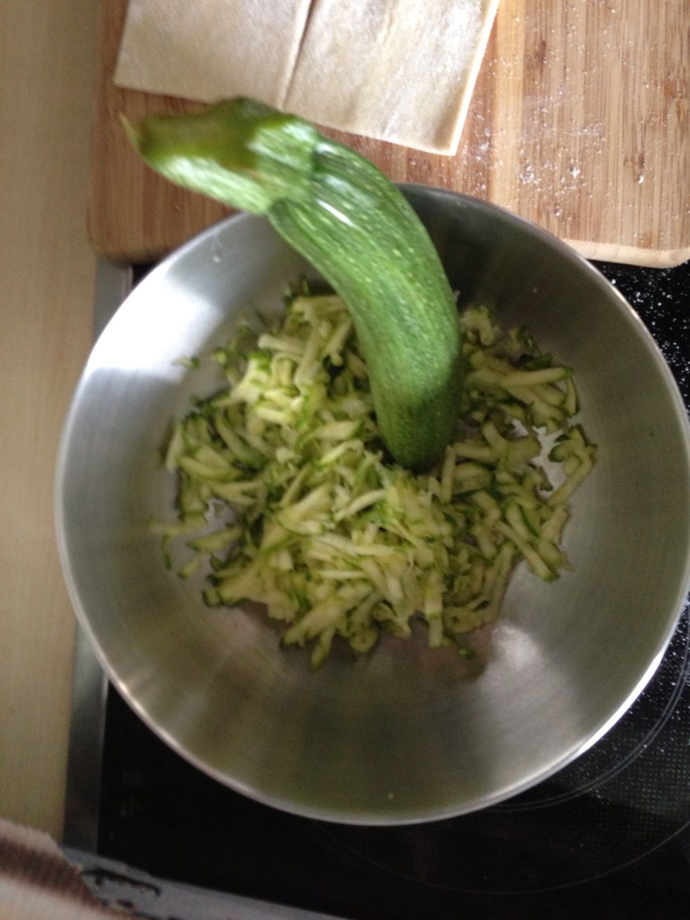 Coarse grind zucchini.
