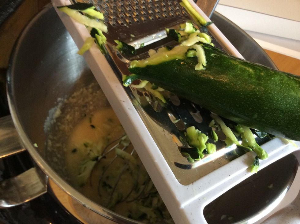 Coarsely shred zucchini into wet mixture.