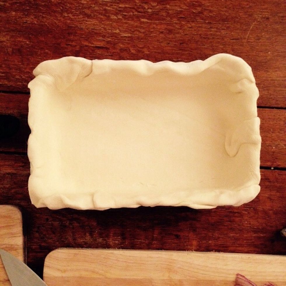 Coat a baking pan with flour and then phillo paste. I like to wrinkle the extra one around the edges, but you can cut it flush if you want.