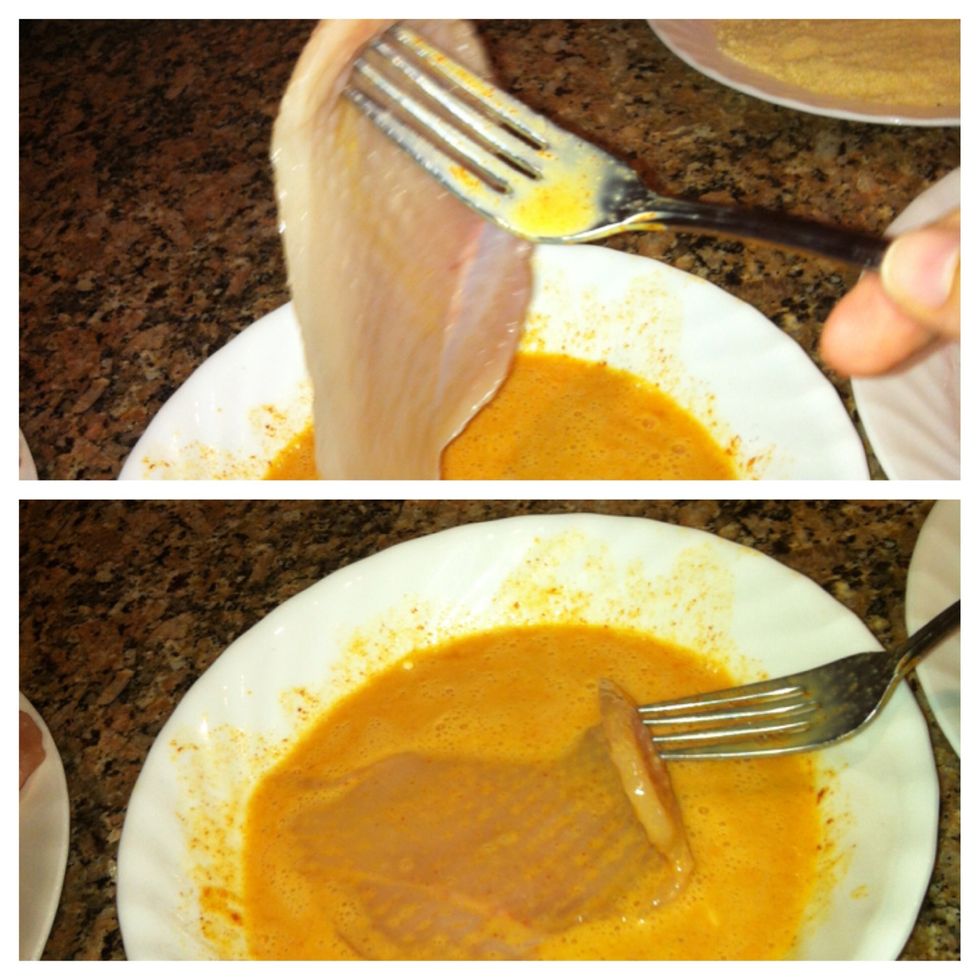 Coat a chicken slice in the egg mixture.