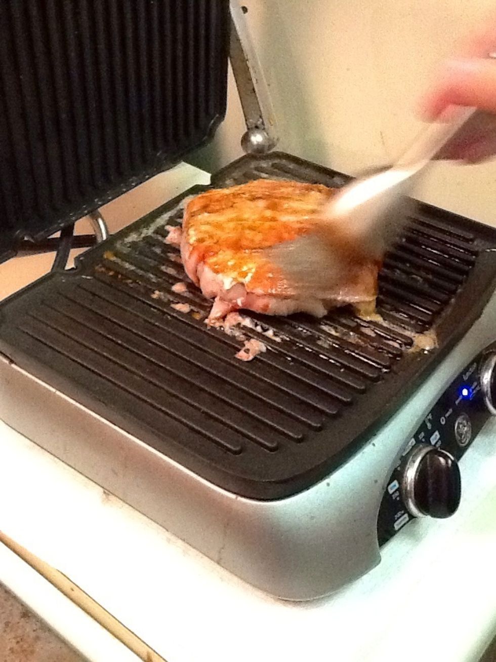 Coat burger in BBQ sauce repeatedly while grilling