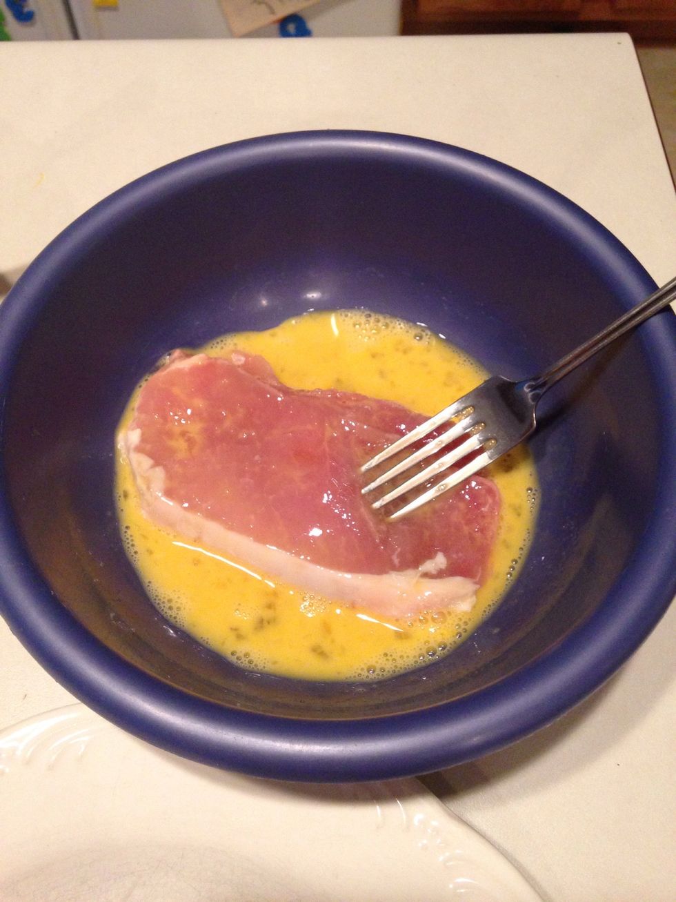 Coat pork in egg.