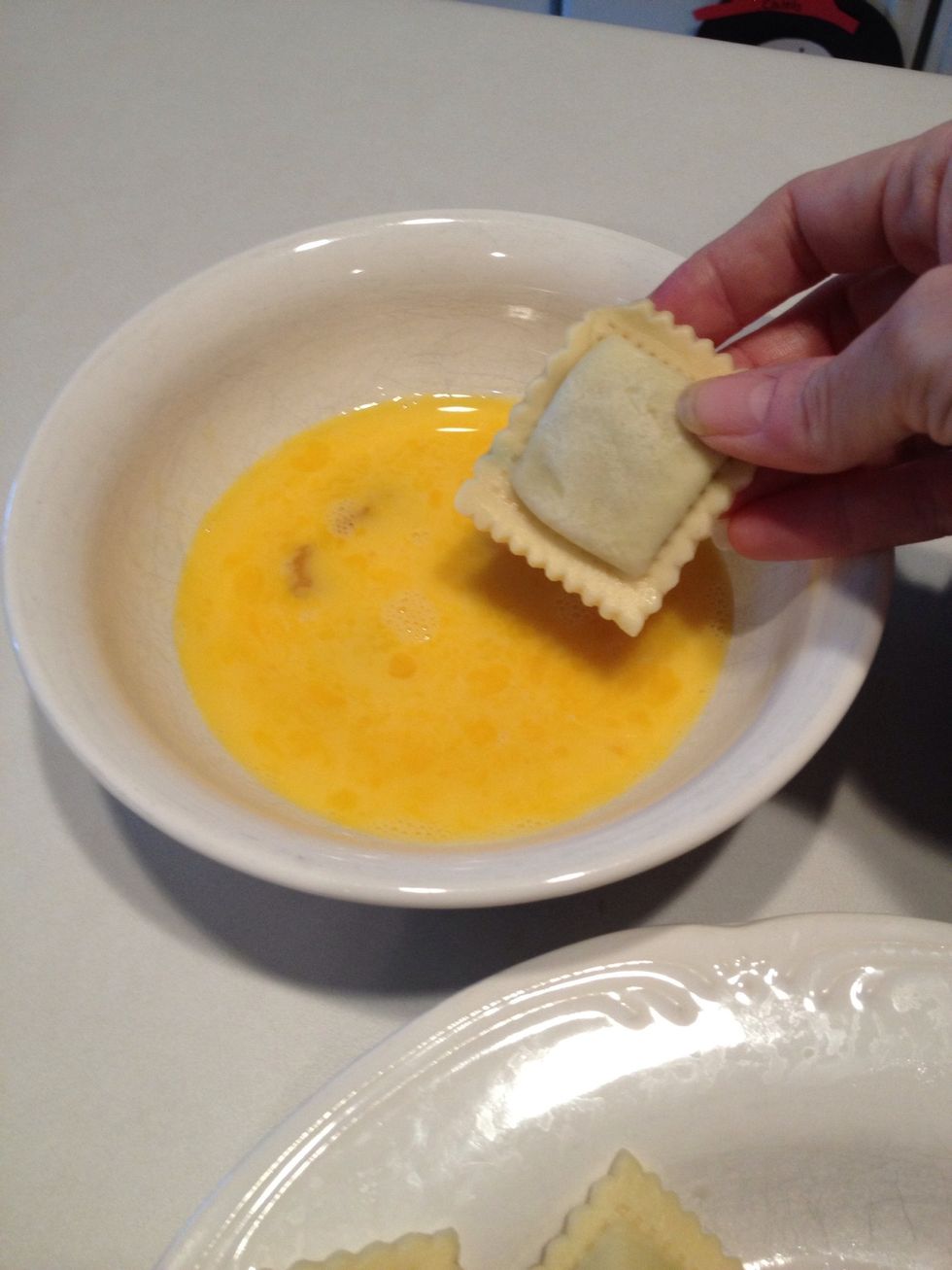 Coat ravioli in egg mixture.