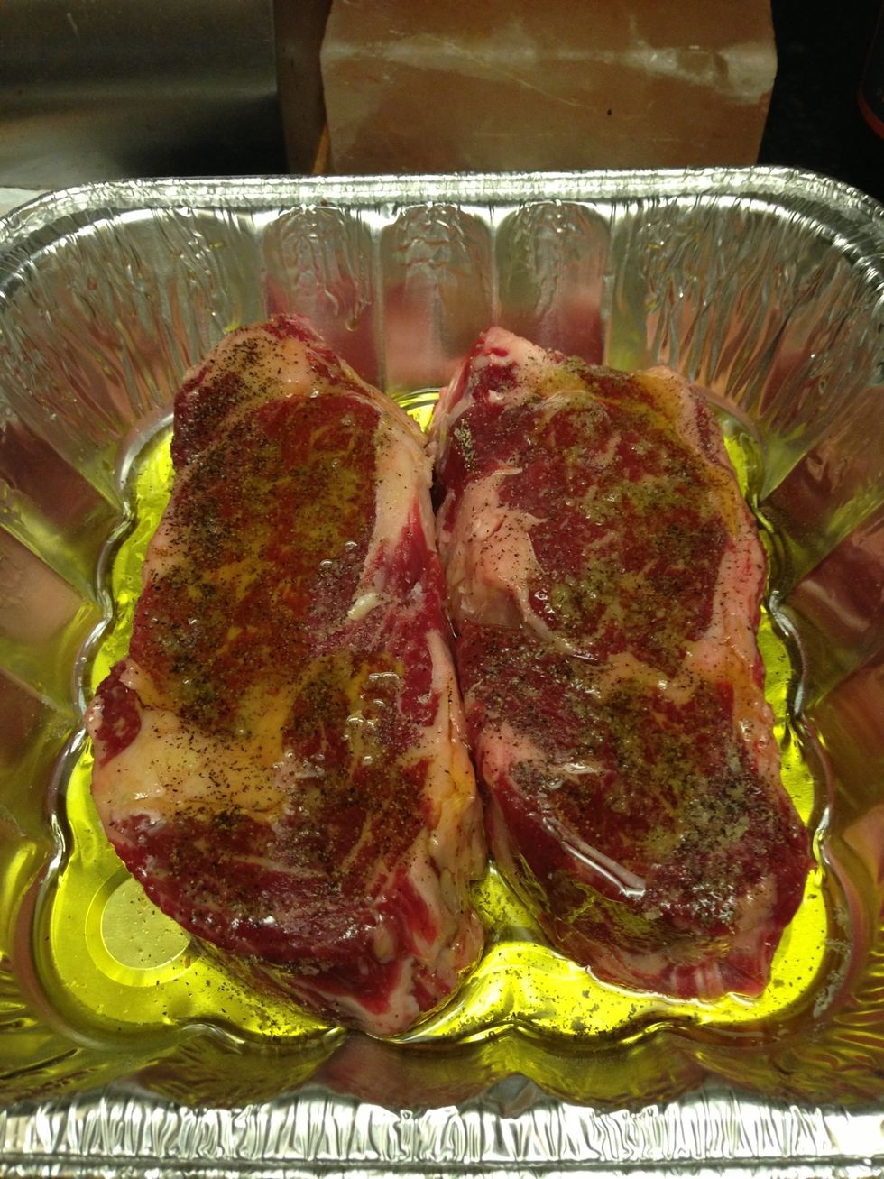 Coat steaks in olive oil. Use a brush to ensure the whole steak is coated (including sides). Move directly to the grill.
