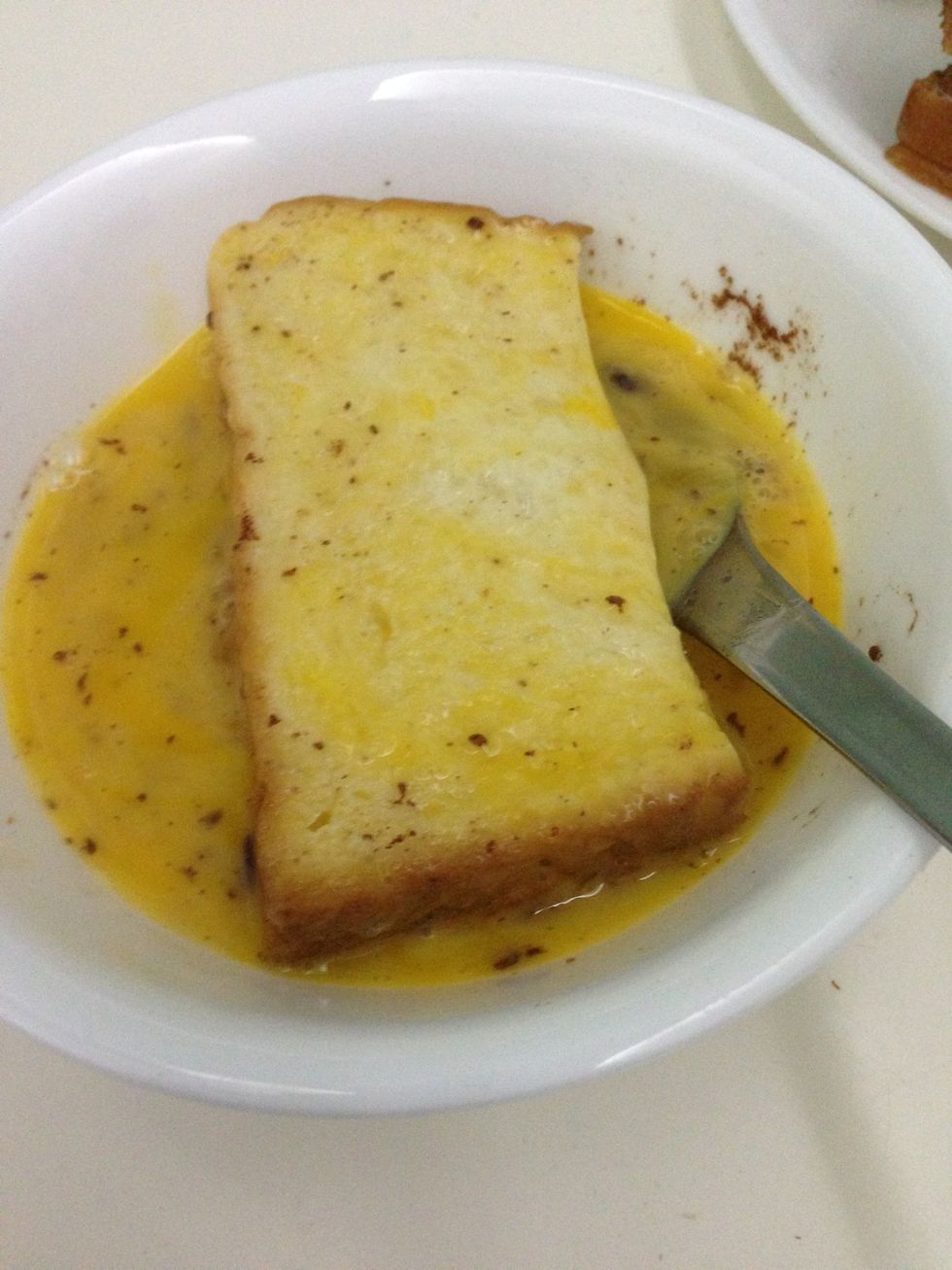 Coat the bread with egg