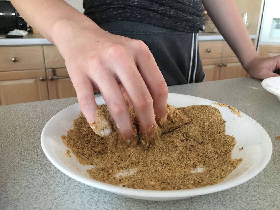 Coat the chicken in breadcrumbs. Ensure that the chicken is entirely covered.