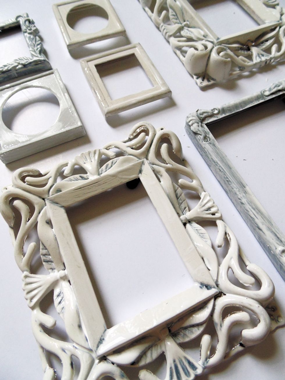 Coat the frames in a layer of white acrylic paint. It will likely wipe off of any raised areas (that's ok!) but be sure to get it into any crevices.