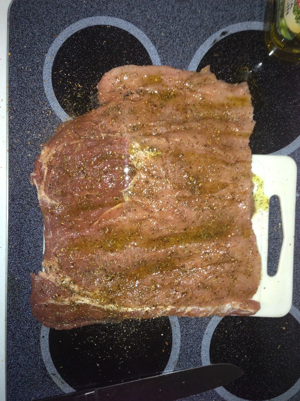Coat the inside (cut side) of the loin with olive oil, then add garlic, rosemary, paprika (not much) and whatever else your heart desires. Just be careful not to overdo it.