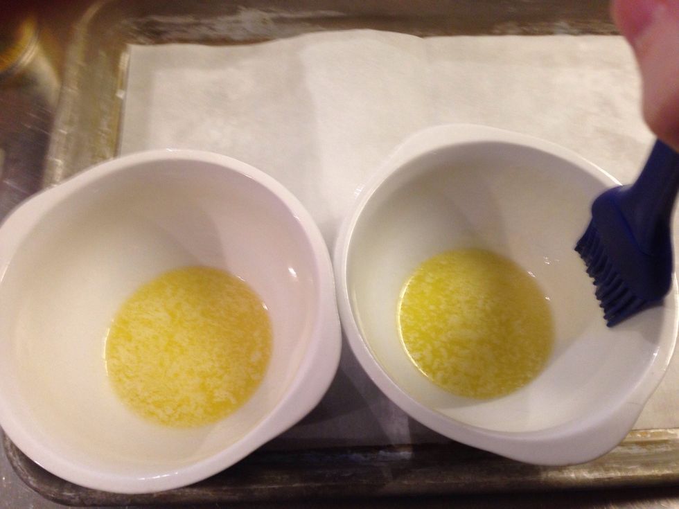Coat the inside of the ramekin with the butter. Place on the parchment lined baking sheet.