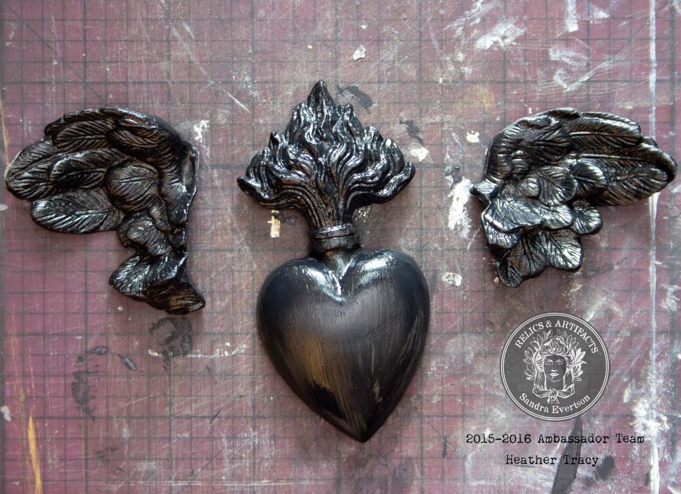 Coat the Relics with Heavy Black Gesso and allow to dry. It won't take long...Once dry, use Black Glass Glitter to coat the Heart Relic, and Black Cherry Mica Powder to coat the Flame Relic.