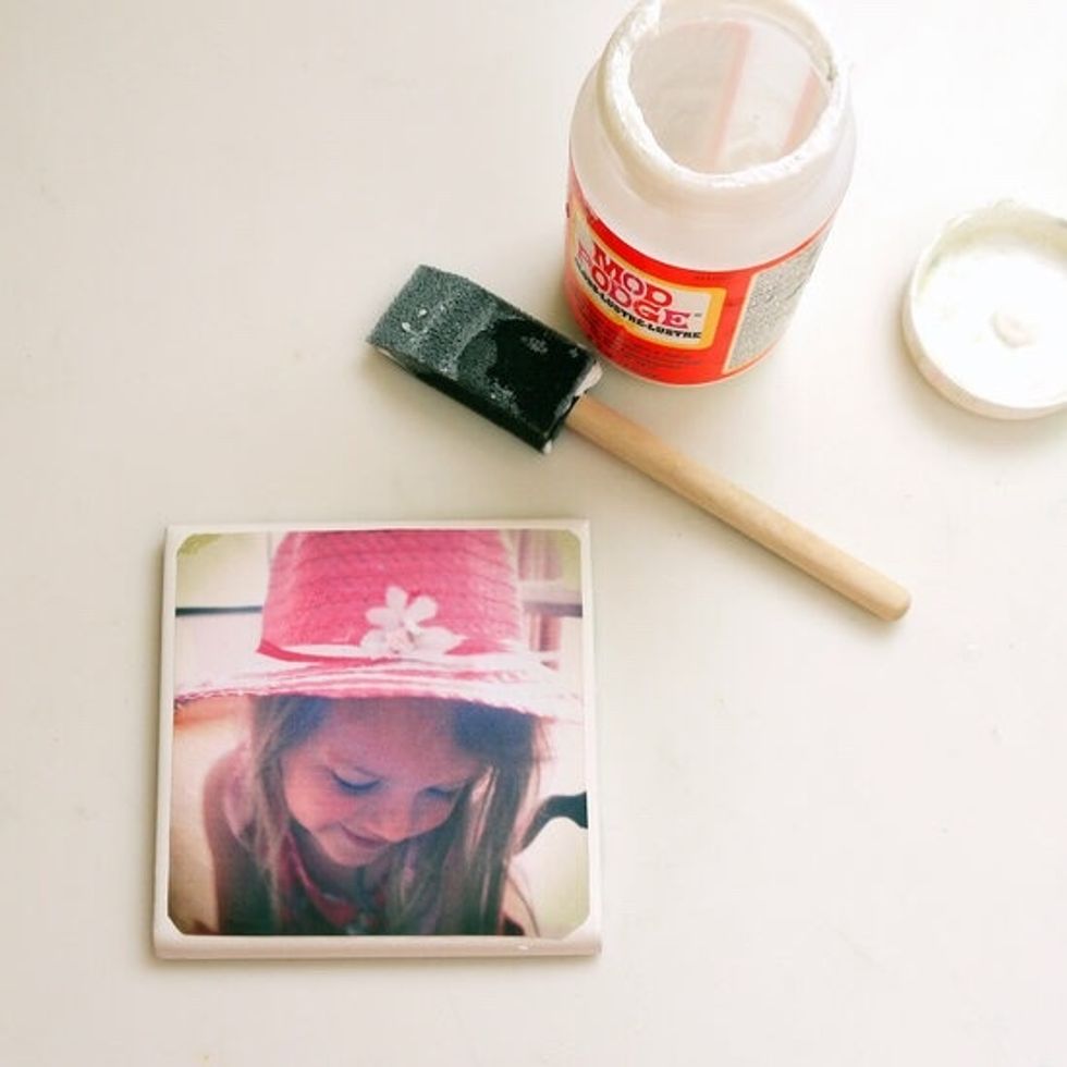 Coat the tile with a thin layer of Mod Podge and press a picture to the tile. Seal the top of the coaster with multiple layers of Mod Podge,and ensuring the photo is completely adhered to the tile.