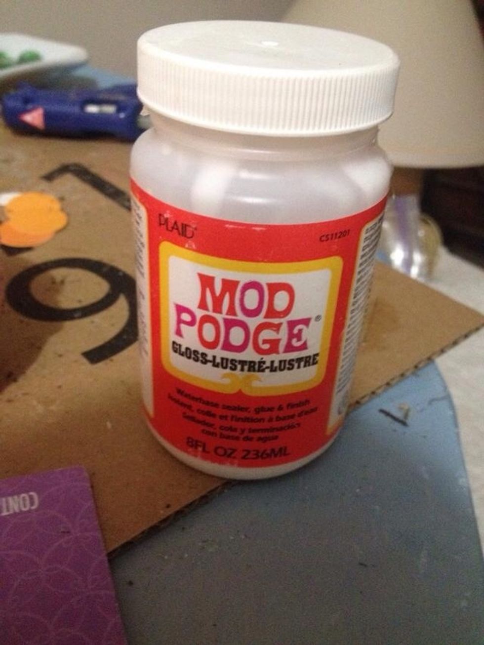 Coat top of tin with glue and place design. Open tin and place face down on table. Cover bottom sides and top of tin with coat of glue, let dry and repeat.