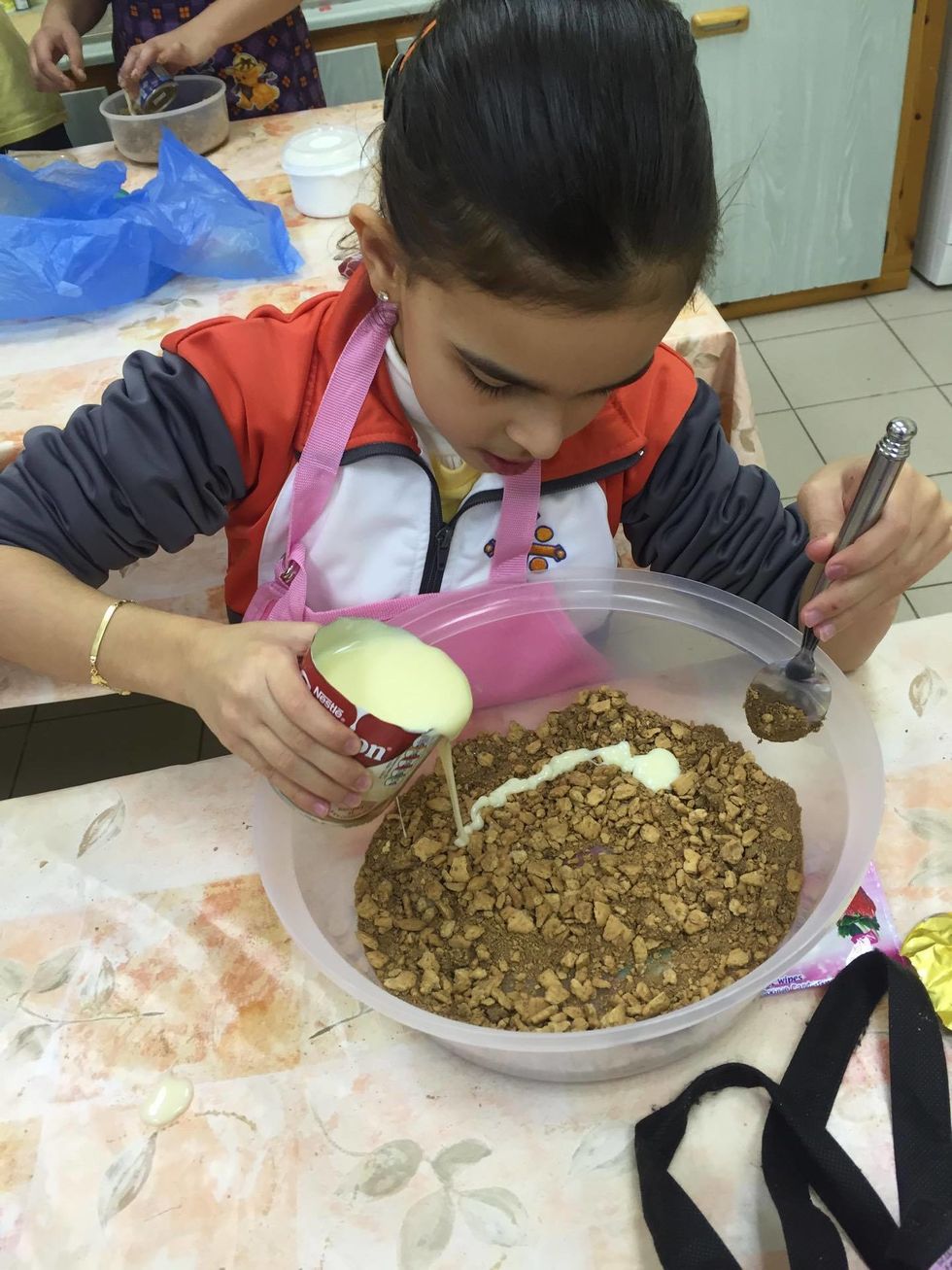 Cocoa power was added....Condensed milk was added to the crushed biscuits to make our mixture moist