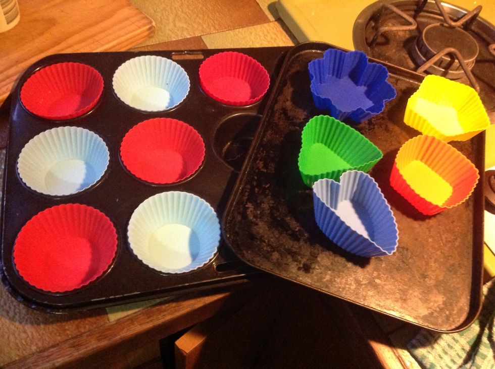 Collect cupcake patties and put on a heat proof tin. If you have different shaped or coloured patties it will look nicer.