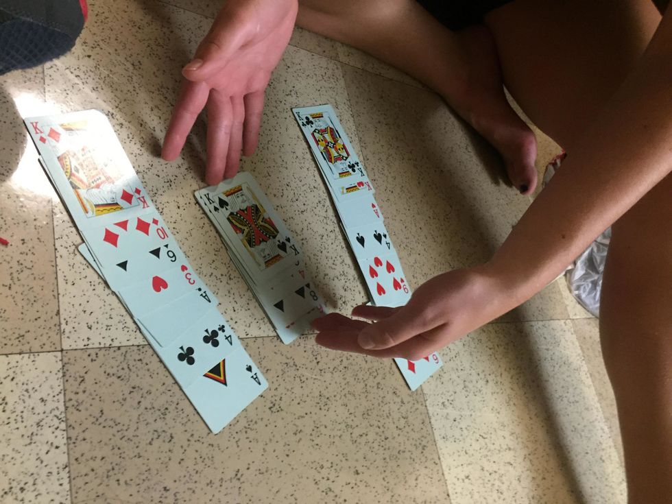 Collect the piles starting with the pile that is to the left of the pile that your participants card is in and then collect the selected pile next eventually collecting all the cards in one pile.