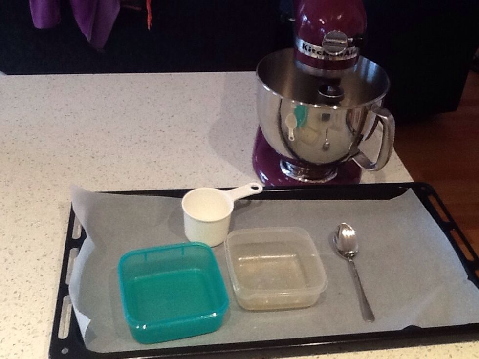 Collect your equipment. You'll need a mixer, 1 cup, 2 containers, a dessert spoon and a baking tray lined with baking paper.