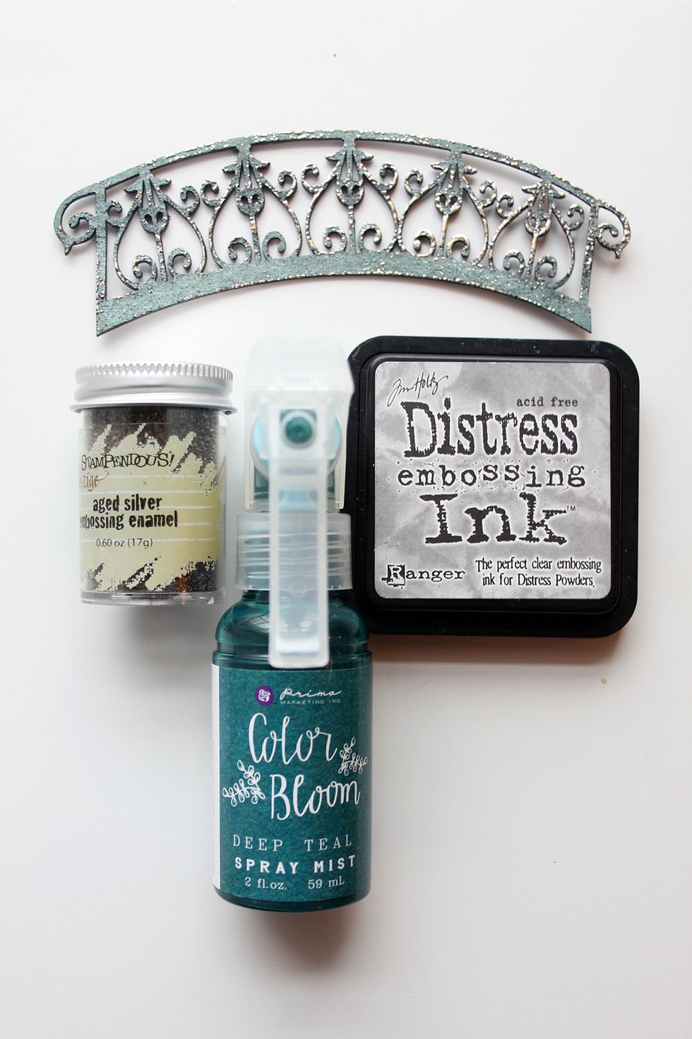Color all chipboard pieces. Spray Color Bloom over entire piece, dry, Apply embossing ink sparlingly, sprinkle embossing enamel over the pieces and heat using a heat gun.