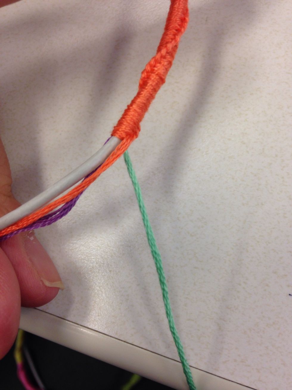 Color switch! To switch colors, just pick up a new color strand and pull that strand away and put the old strand with the rest of the bunch! Then continue making knots!