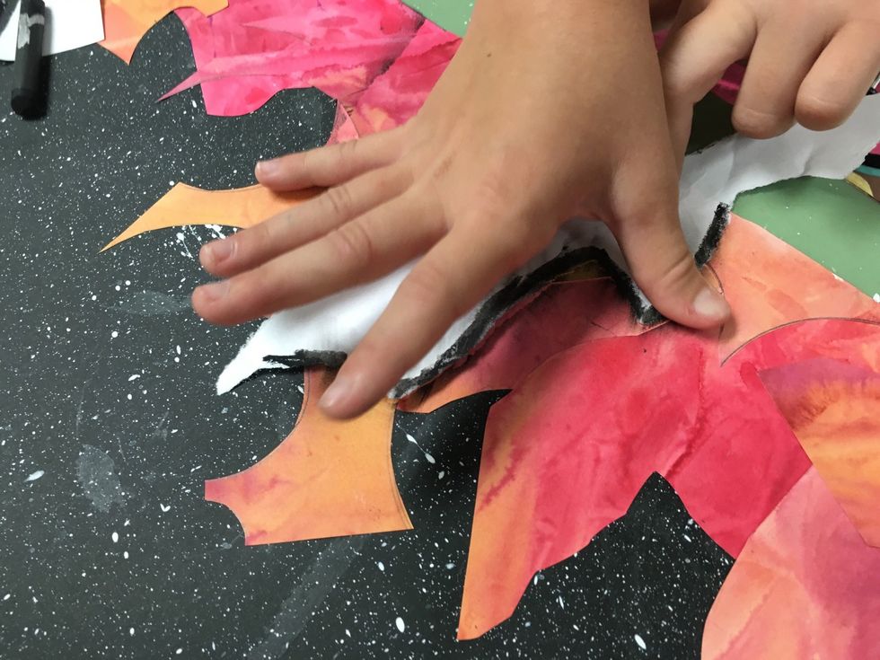 Color the edge with black oil pastel and lay it over the rough landscape you created. Rub you finger across it leaving an impression on the art below.