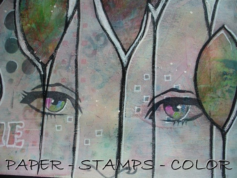 Color the eyes with a pink, green and blue watercolor pencil, and add some white with a white acrylic marker as shown.