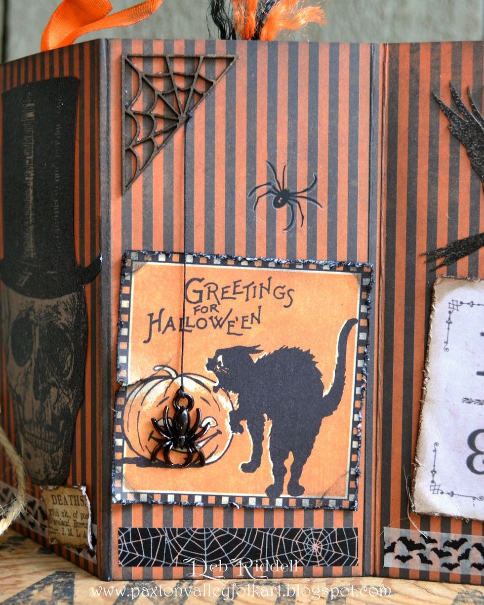 Colour a chipboard spider web with Mushroom alcohol ink. Colour the Oddities Adornments spider with black alcohol ink and suspend it from the web with black button thread.