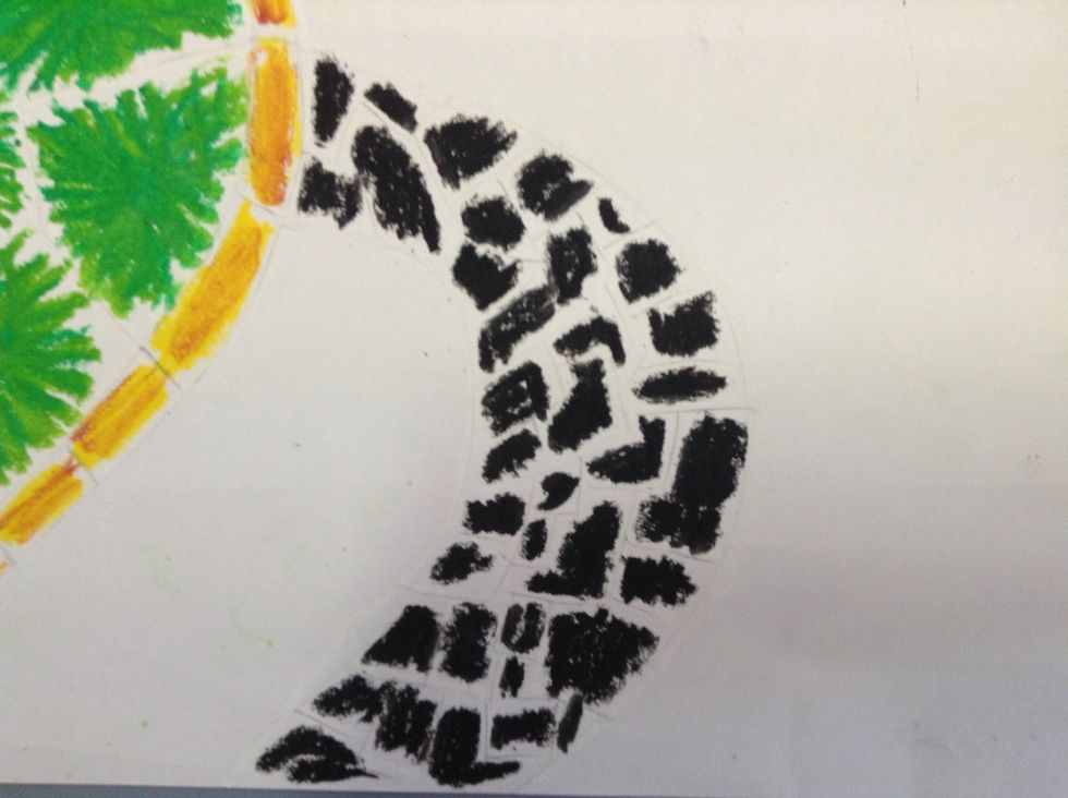 Colour in all the flippers, the tail and the head with black oil pastel.