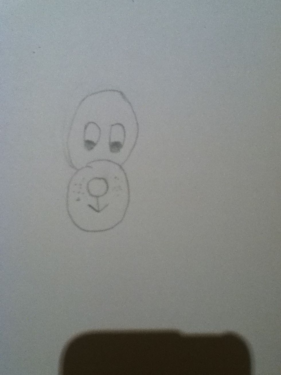 Colour in the bottom thirds if the small ovals, this makes the eyes. Then you can add some little dots next to the mouth to represent whiskers.