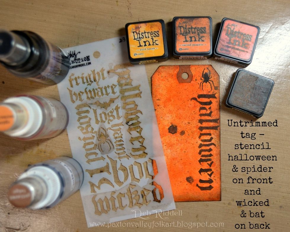 Colour the full sized tag with Distress inks (Wild Honey, Spiced Marmalade, Carved Pumpkin) and spray with the same Distress Stain sprays as for the trimmed tags. Edge the tag with Black Soot DI.