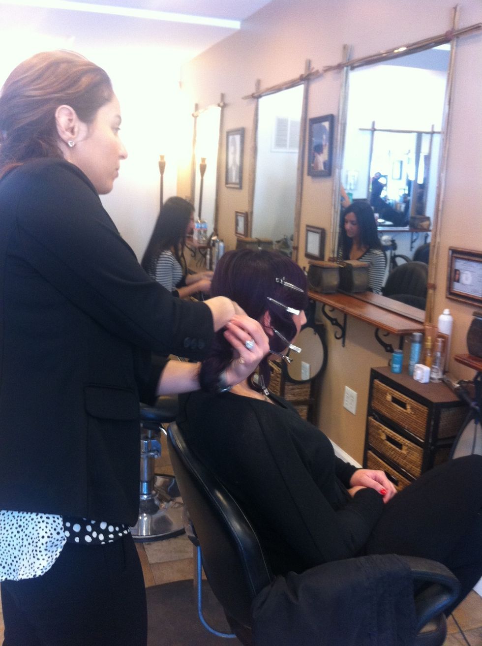 Comb lightly over teased hair and create a low-pony on the desired side of the head..