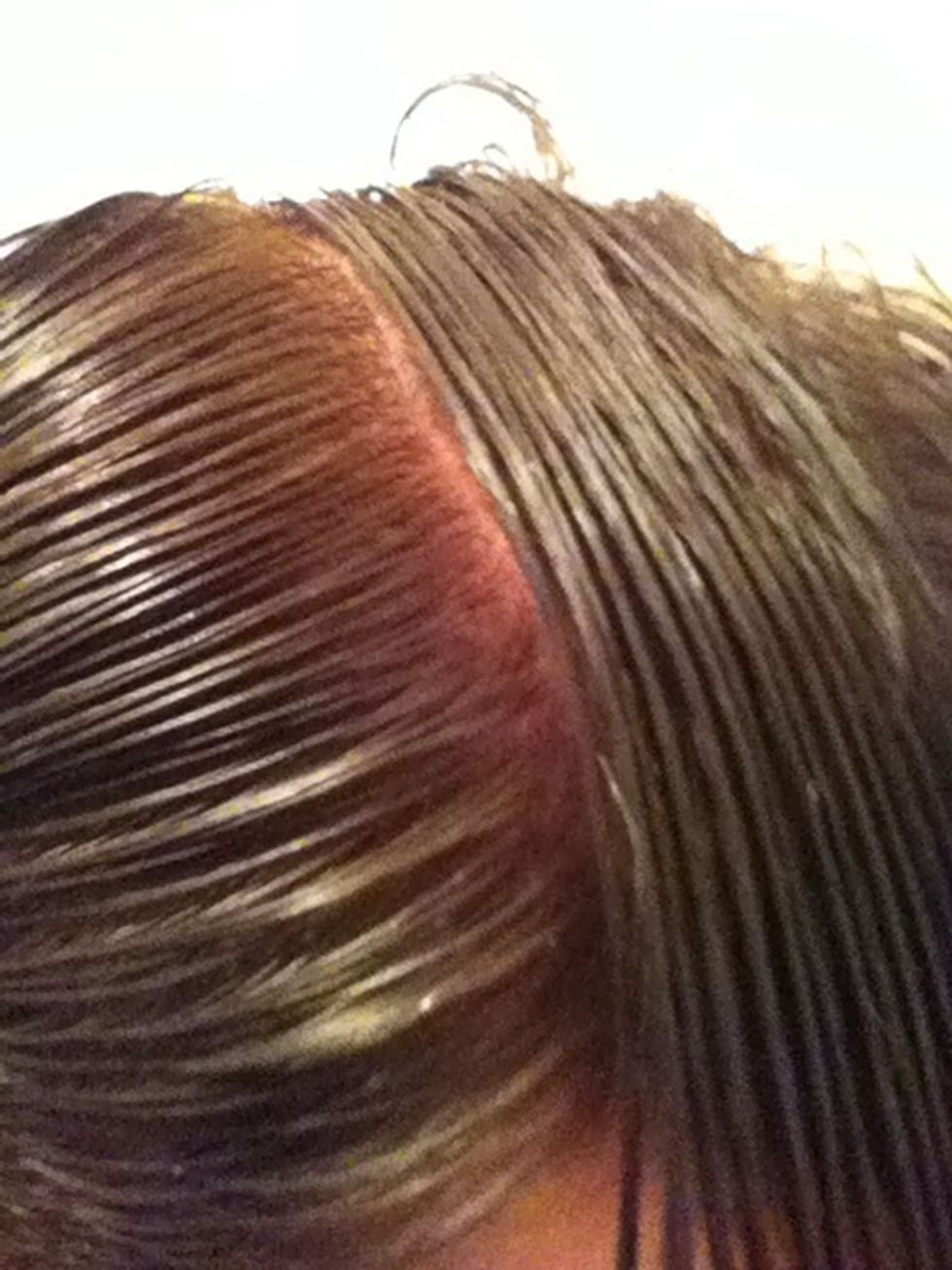 Comb one side of the hair straight down away from the part. Do the same thing in the opposite direction on the other side of the part.