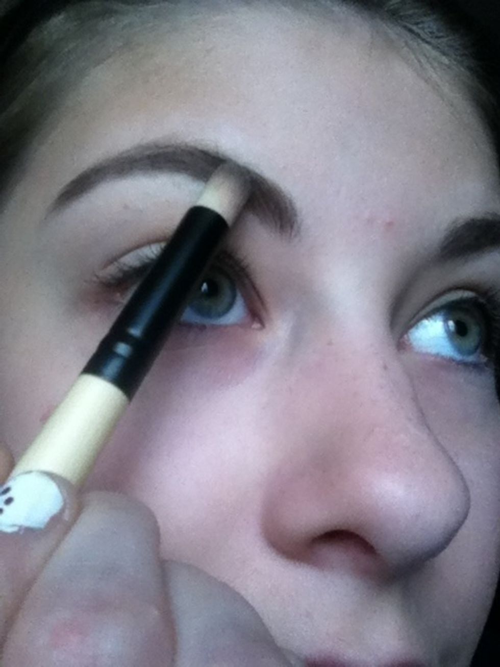 Comb through and lightly fill in your eyebrows.