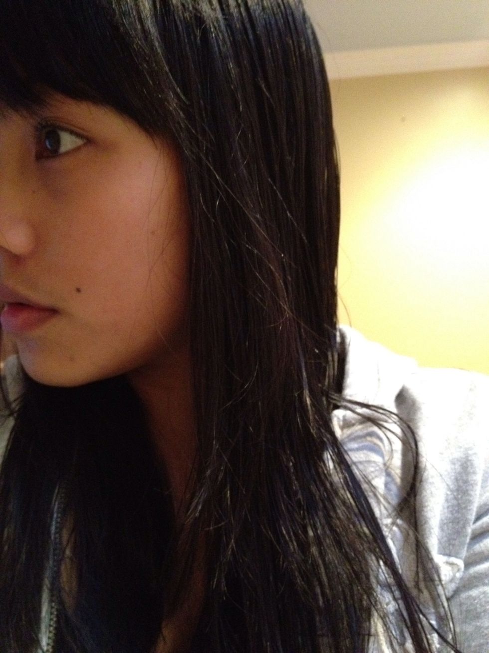 Comb your damp hair and section it into two parts.