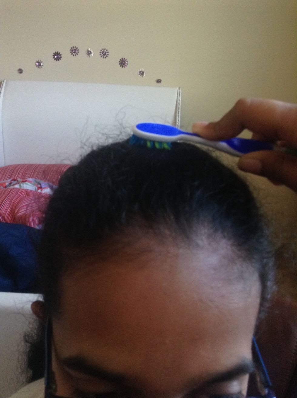 Comb your hair back with the hairspray.