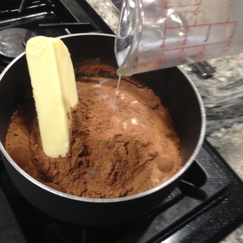 Combine 2 cups of sugar, 4 tablespoons of cocoa, 8 tablespoons of butter, and 1/2 cup of milk in a pan.