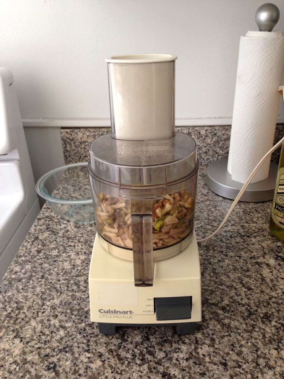 Combine all of the nuts in the food processor. Blend for about 15-20 seconds until all nuts are thoroughly chopped. If you don't have a food processor, look for pre-chopped nuts at the grocery store.