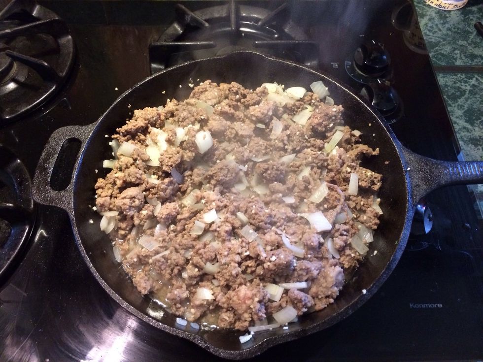 Combine and brown the ground beef and Italian sausage with finely diced onion and diced garlic. You will want to season the meat with a pinch of each spices. Drain sloppy grease and return to pan.