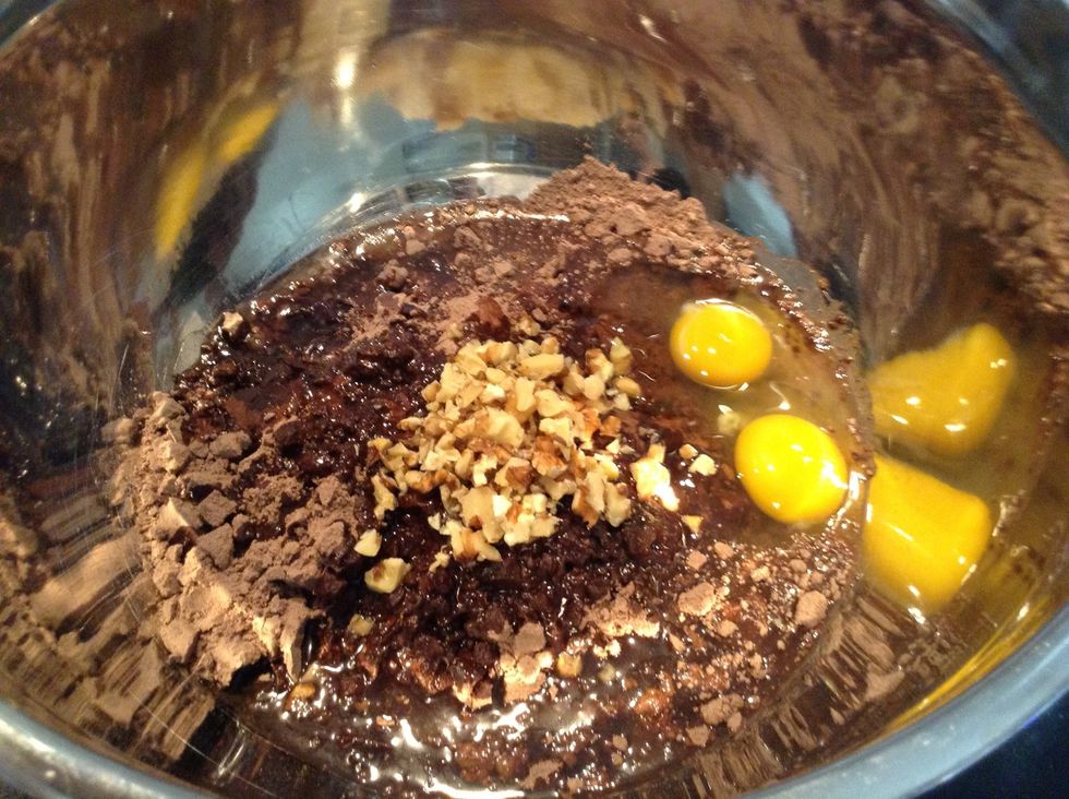 Combine Brownie mix, water, oil, 2 eggs, chocolate chips, and walnuts.
