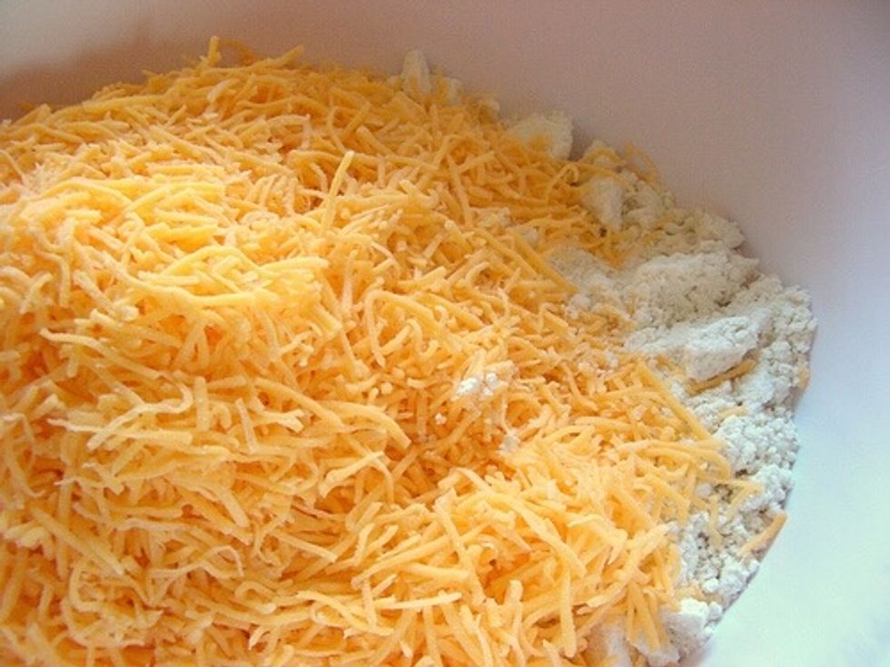Combine Cheddar and Mozzarella cheese in a small bowl