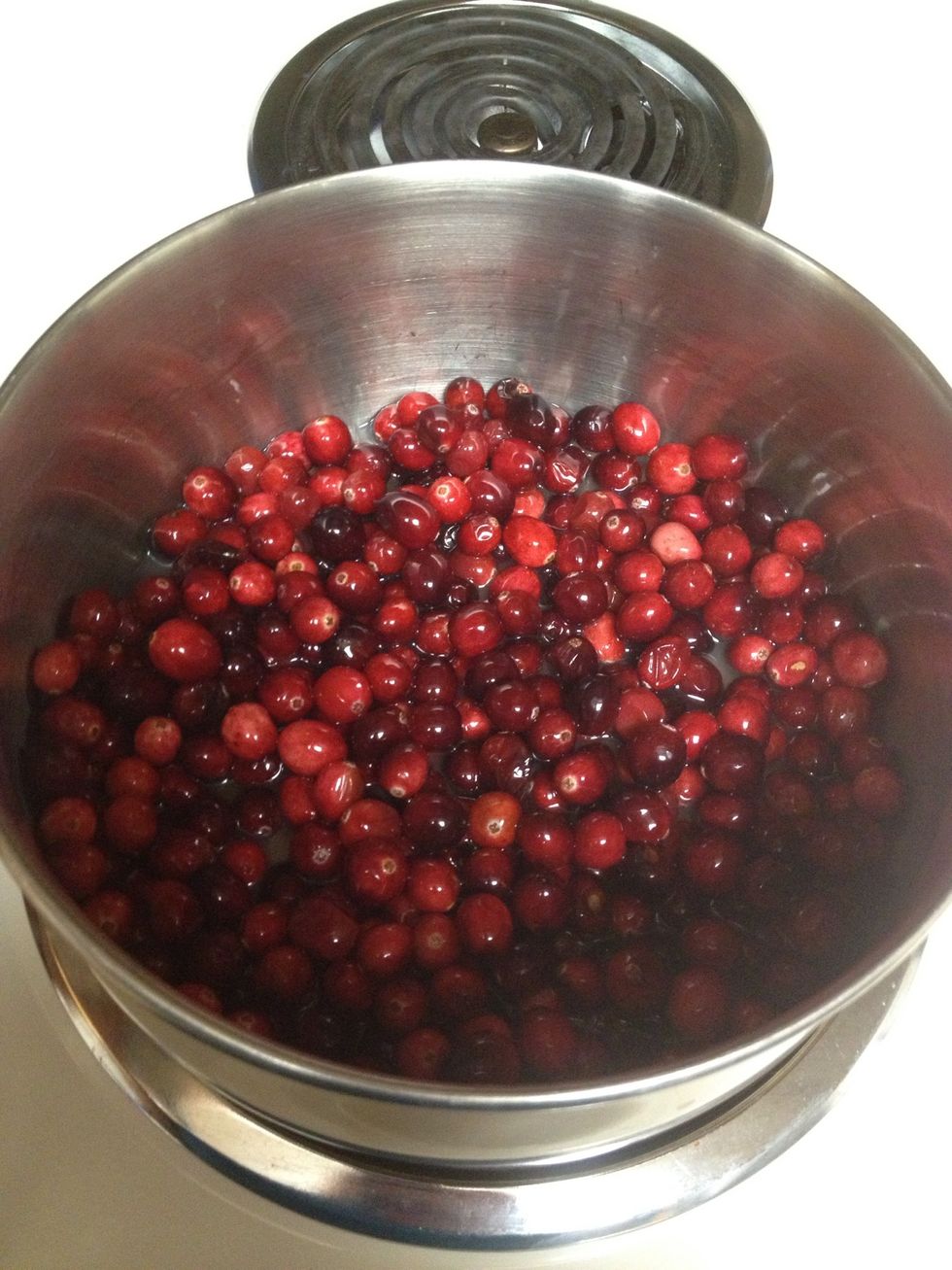 Combine cranberries, water & lemon juice in a pan over medium high heat, stirring occasionally. Once they come to a boil, reduce heat & simmer.