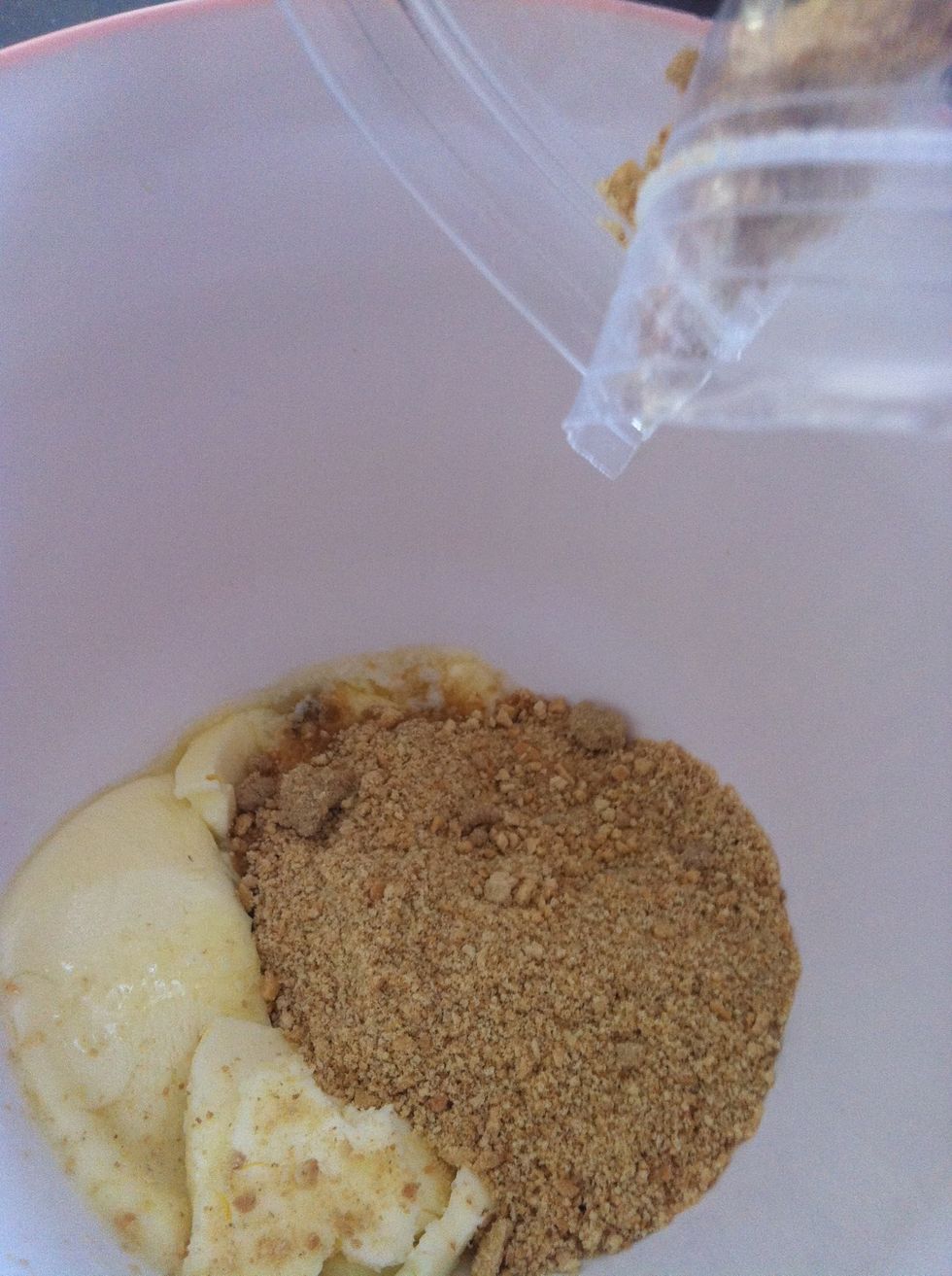 Combine crushed graham cracker crumbs along with melted butter. You may crush your graham crackers with a food processor or with a wooden roller by hand.