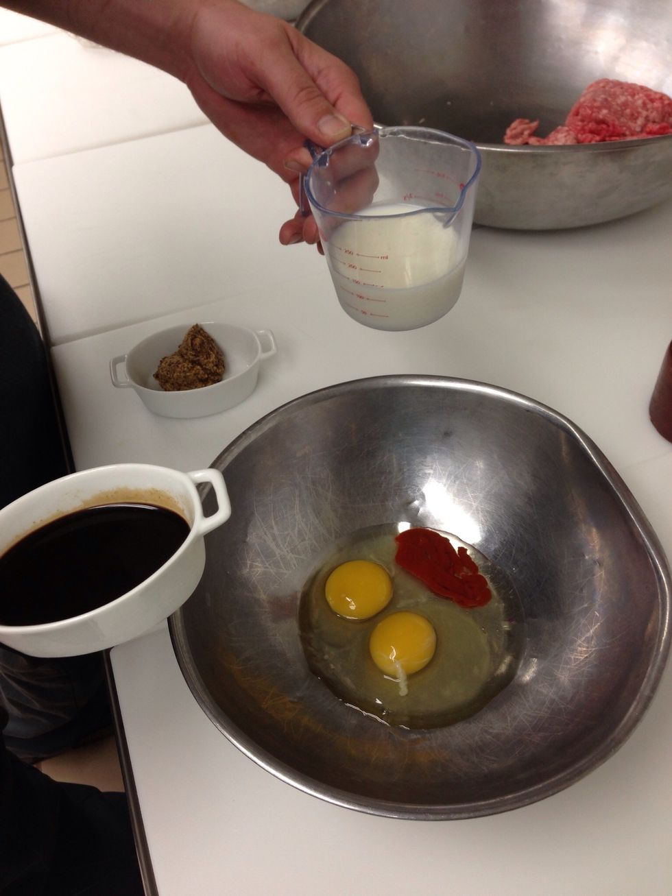 Combine eggs, Sriracha, Worcestershire sauce, mustard, milk, salt, and pepper