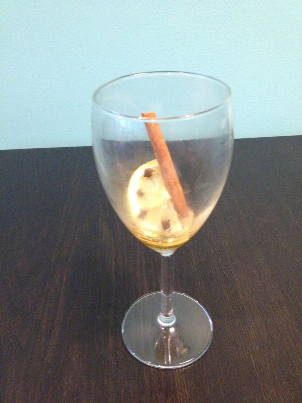 Combine honey, lemon slice, and cinnamon stick in glass / mug.