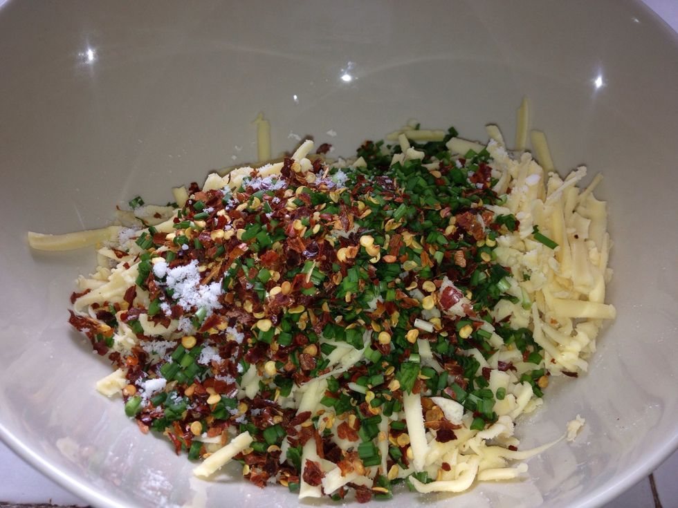 Combine olive oil, garlic chives, cheese and crushed chili flakes in a stand mixer and beat well. I prefer to use my hand to have it done though. Add the flour, salt and garlic powder. Stir to combine