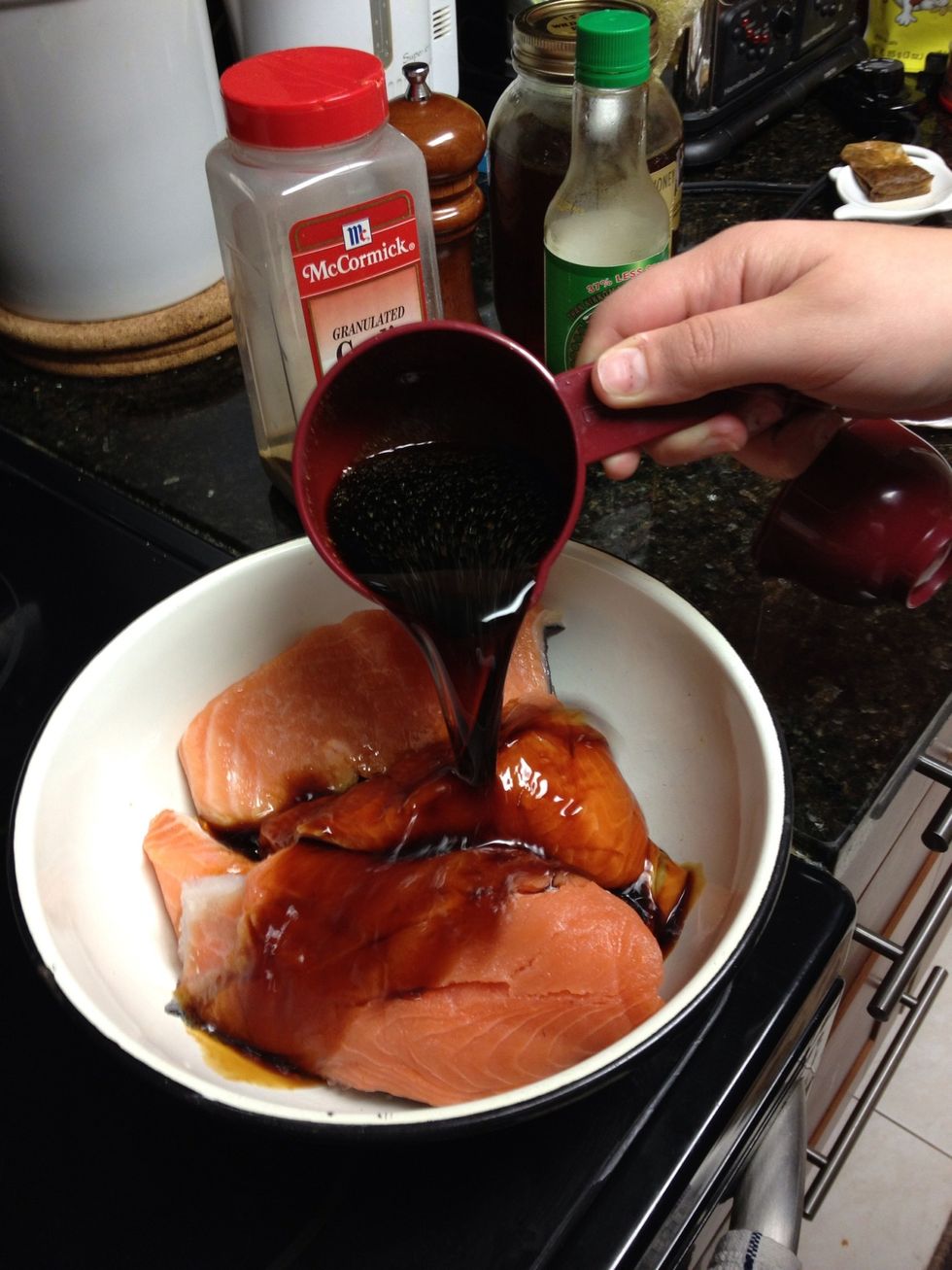 Combine olive oil, soy sauce and garlic and pour over your salmon.Season with black pepper, as much or as little as you like.