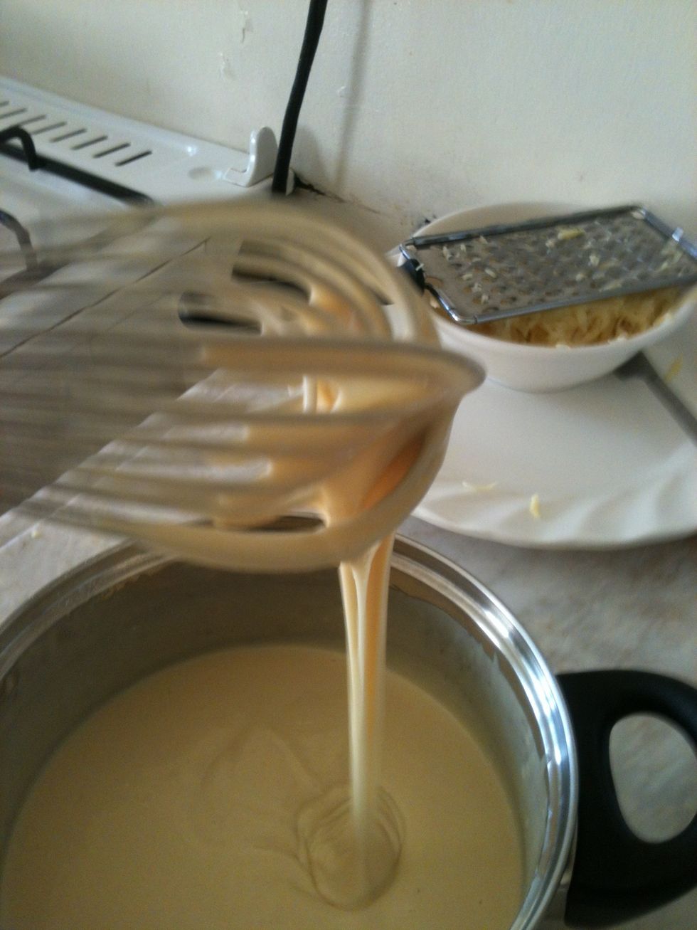 Combine pancake mix and enough milk to get it to a smooth, creamy, near-thin consistency like this. Milk instead of water brings out the cheese taste, and makes the pancakes a little thicker.